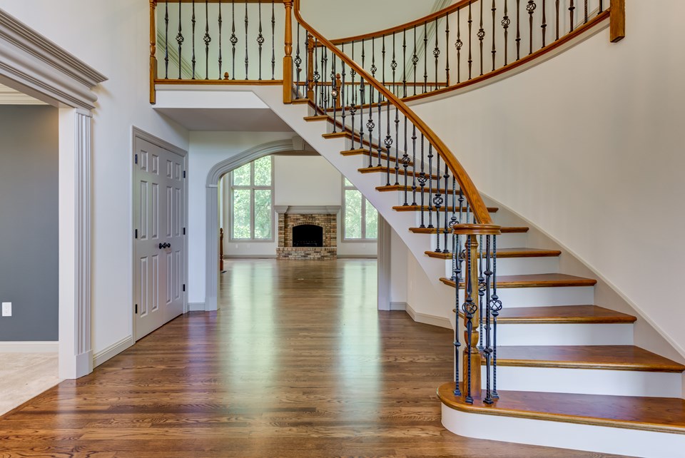 custom curved staircase with metal baluster