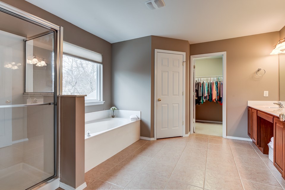 separate tub and shower with his and her sinks and 2 oversized walk-in closets