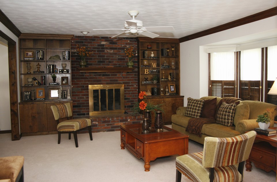 family room  cozy & warm the spacious family room offers brick wood-burning fireplace framed by built-in bookshelves and large bay window. the famliy room opens into the bright breakfast room and kitchen.